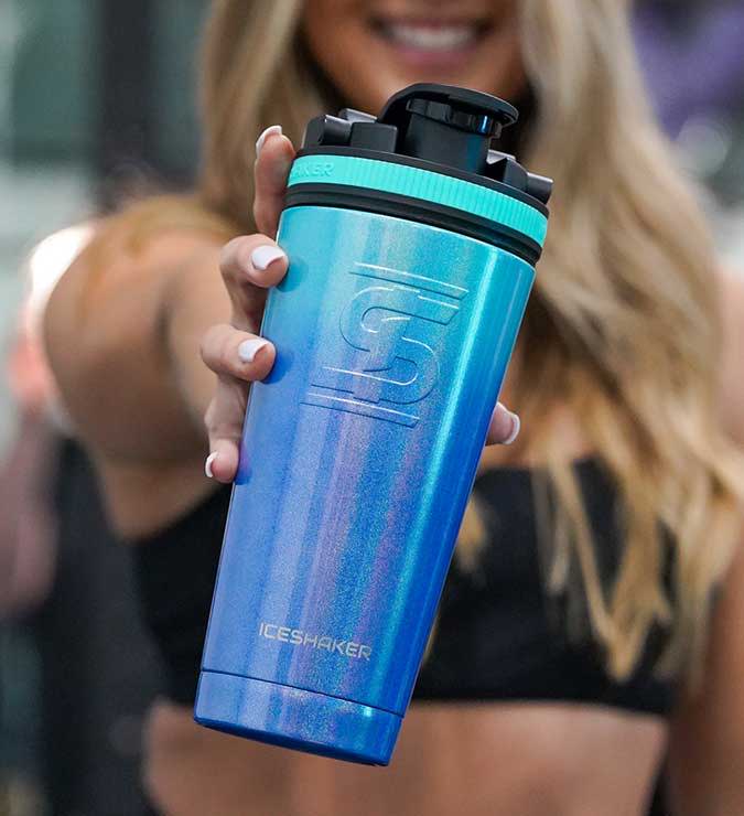 an image of a blonde girl holding a 26oz. Mermaid Blue to Teal Ombre Shaker Bottle
