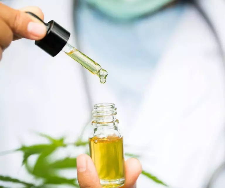 CBD oil being used in a tincture dropper