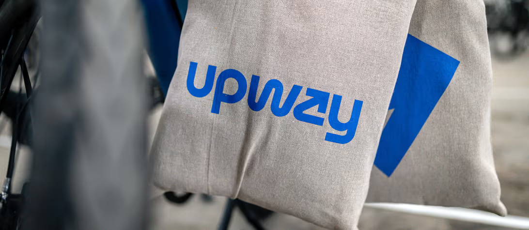 an Upway tote bag hanging off a bike