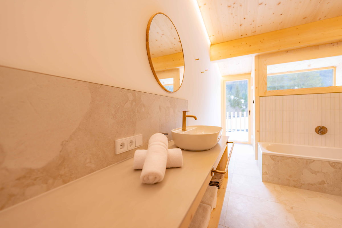 Badezimmer mit Waschbecken und Badewanne im Apartment Fux & Has von Hugo & Pepi in Mittelberg im Kleinwalsertal.