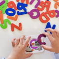 Child playing with a letter and a card from the Montessori ABC Matching Cards set.