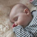 A baby sleeping on sheepskin
