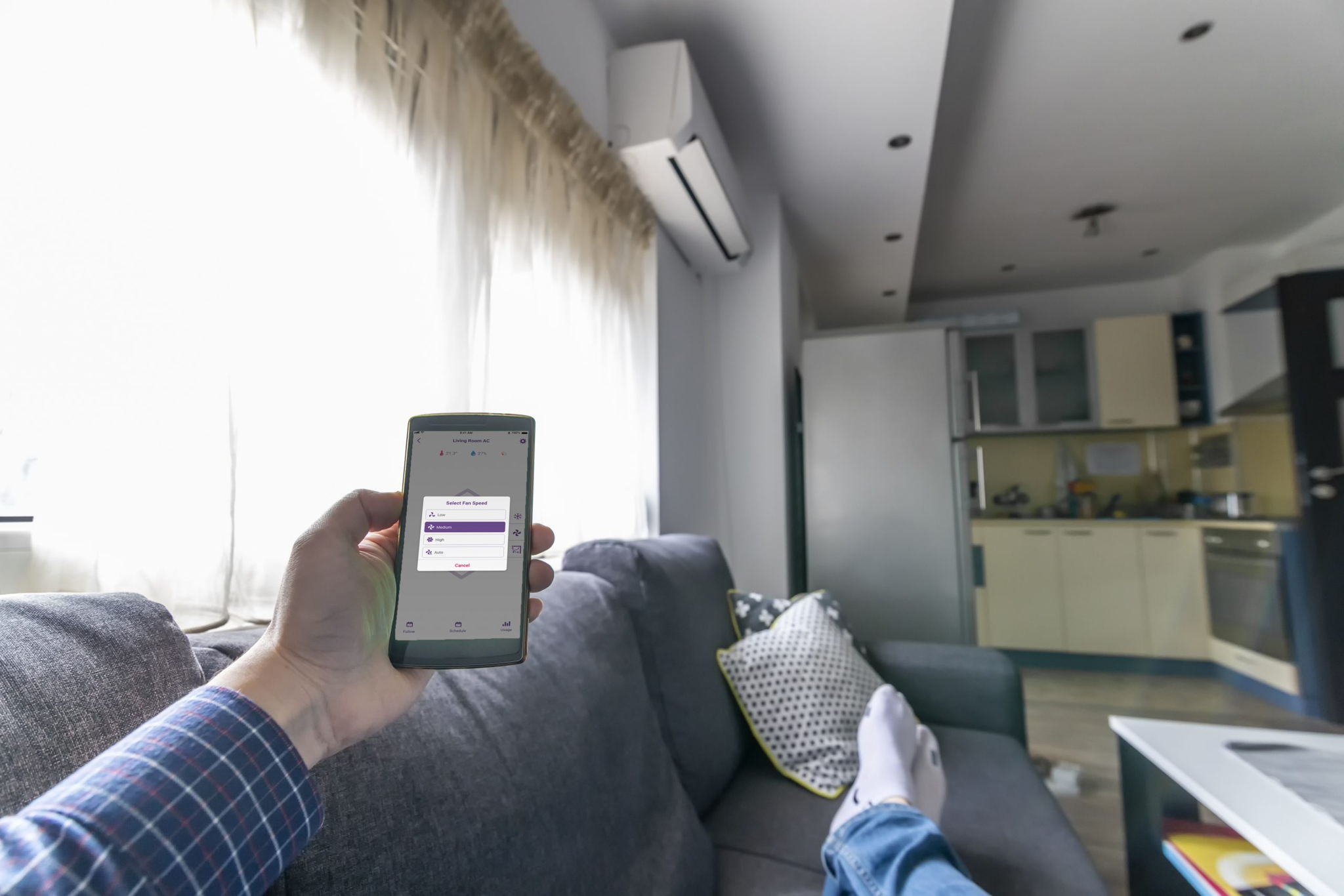 man controlling mini split fan speed from smartphone app