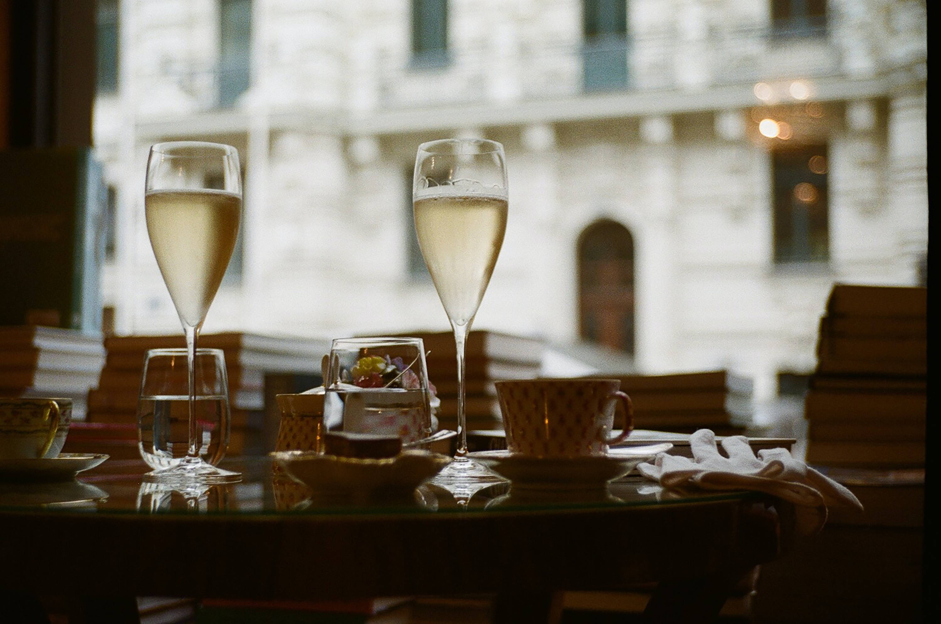 Restaurant table found in French city centre consisting of two gasses of Champagne and coffee cups. 