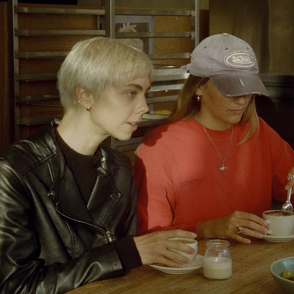 People sitting outside busy cafe 
