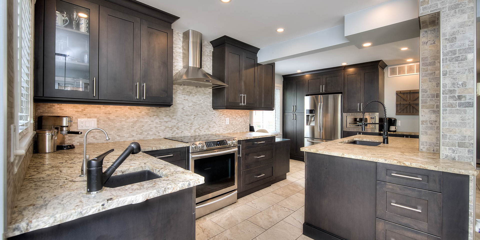 kitchen featuring ventilation hood, refrigerator, electric range oven, light tile floors, dark brown cabinets, and light stone countertops