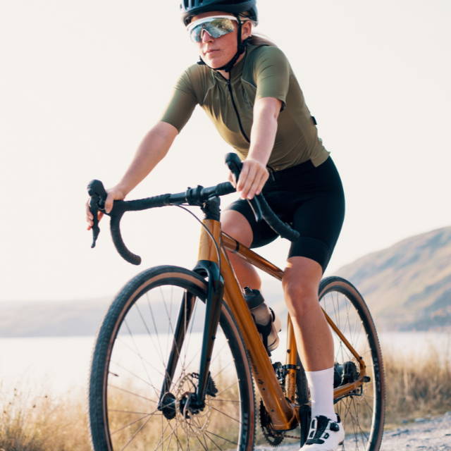 a woman riding an electric La Pierre road bike in the gravel