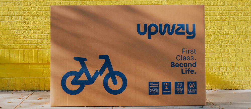 an upway bike box in front of a yellow brick wall