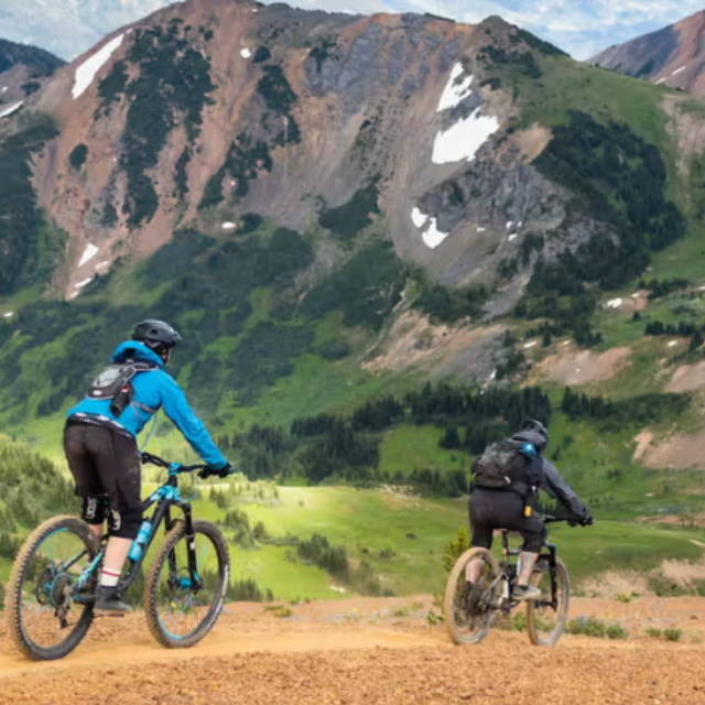 2 people mountain biking in the mountains