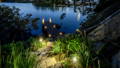 Landscape lighting highlighting waterfront garden and jetty access