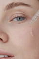woman applying retinol on her face