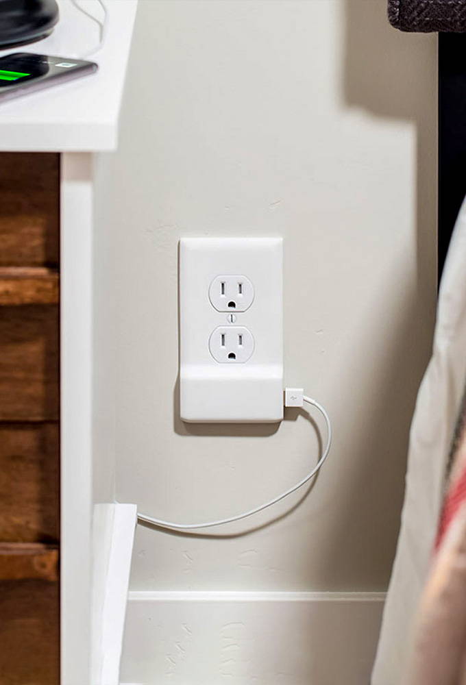 Single USB charger outlet plate on a white wall