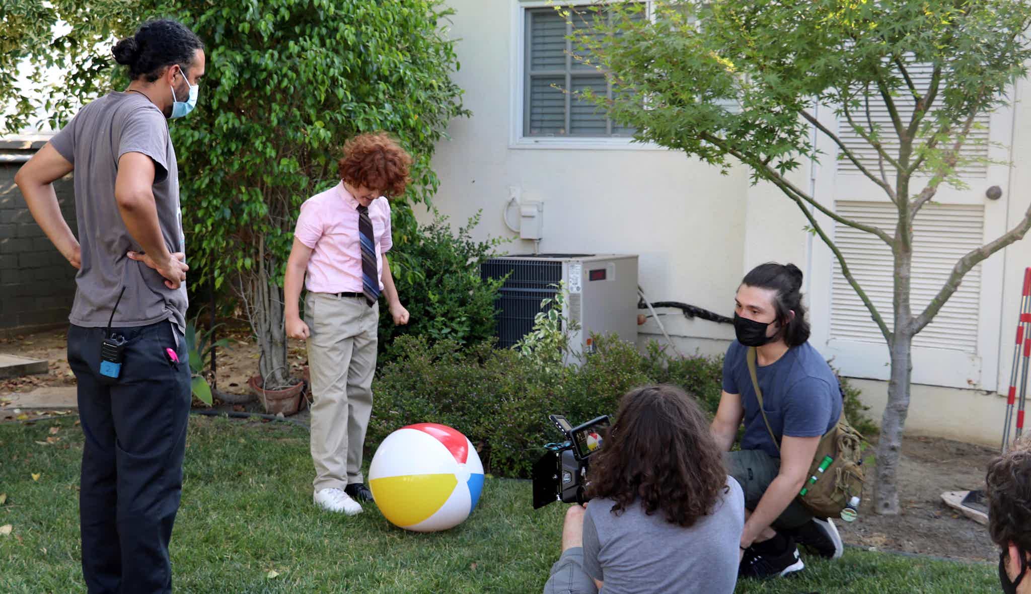 Mason C. Wells, who plays Odom the IRS neighbor's son, prepares to stomp on the twins beachball.