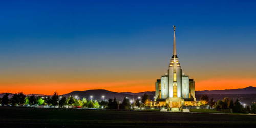 Rexburg Temple picture of an orange sunset against a deep blue sky.