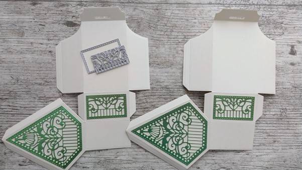 a group of white boxes with green designs
