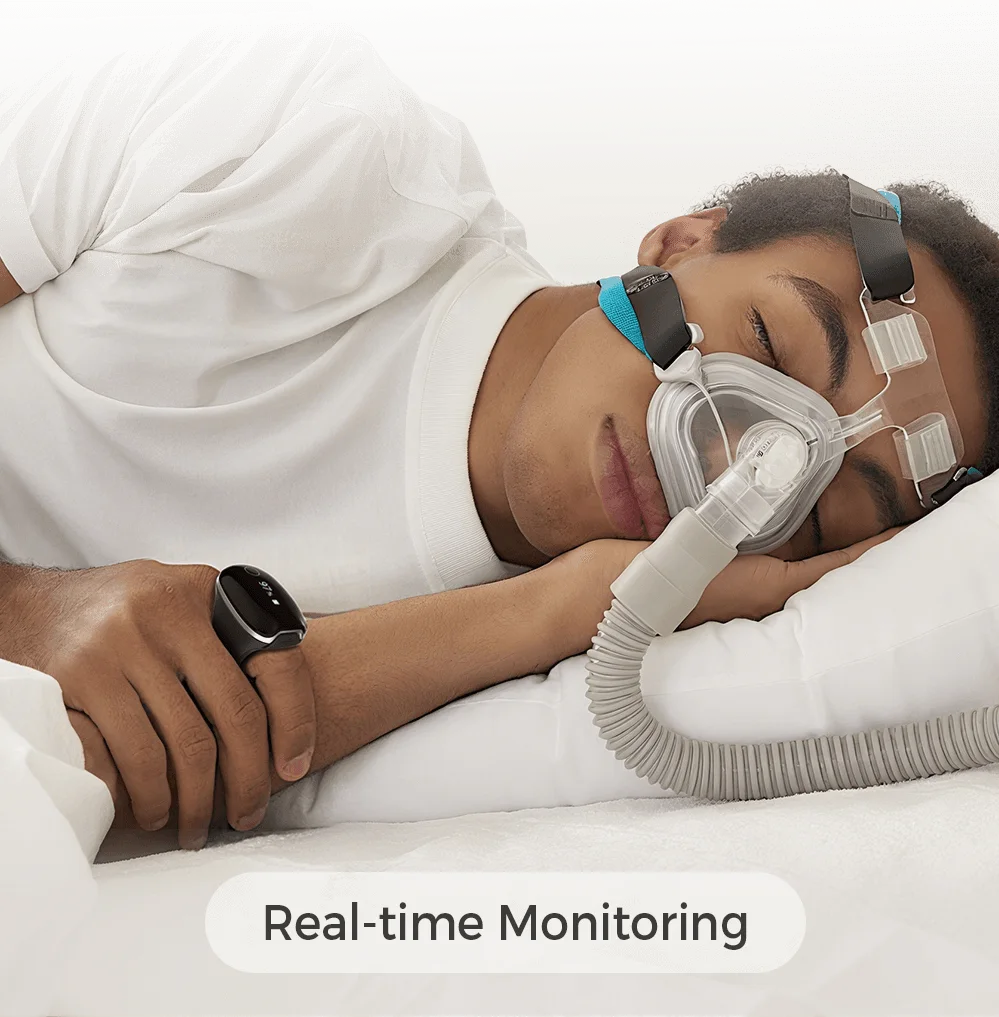 Man sleeping with CPAP mask and Wellue O2Ring-S for real-time oxygen monitoring