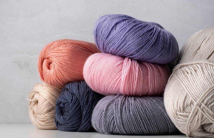 Skeins of yarn laid out next to a laundry care label