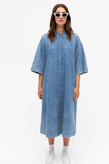 Woman wearing blue indigo organic cotton shirt dress