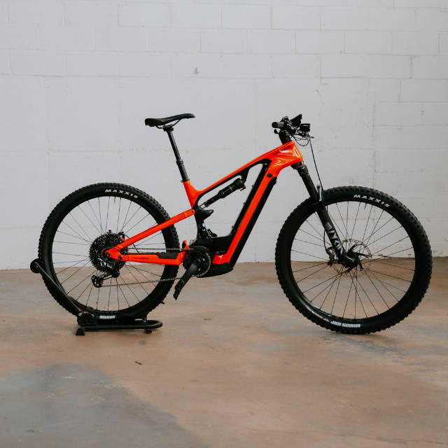 a red Cannondale Moterra full suspension electric mountain bike