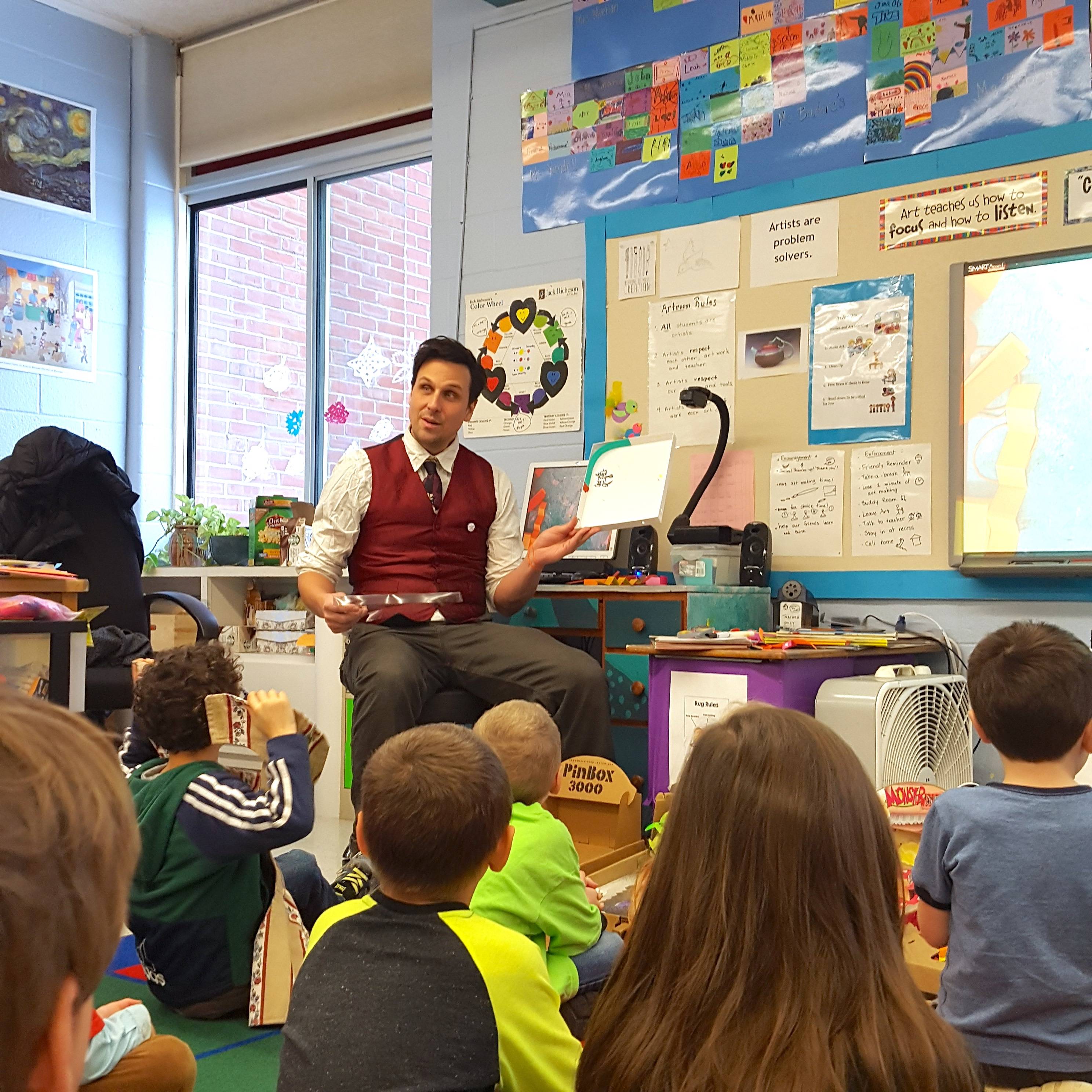 Ben works with students to design pinball games.