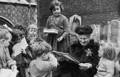 Maria Montessori surrounded by children.