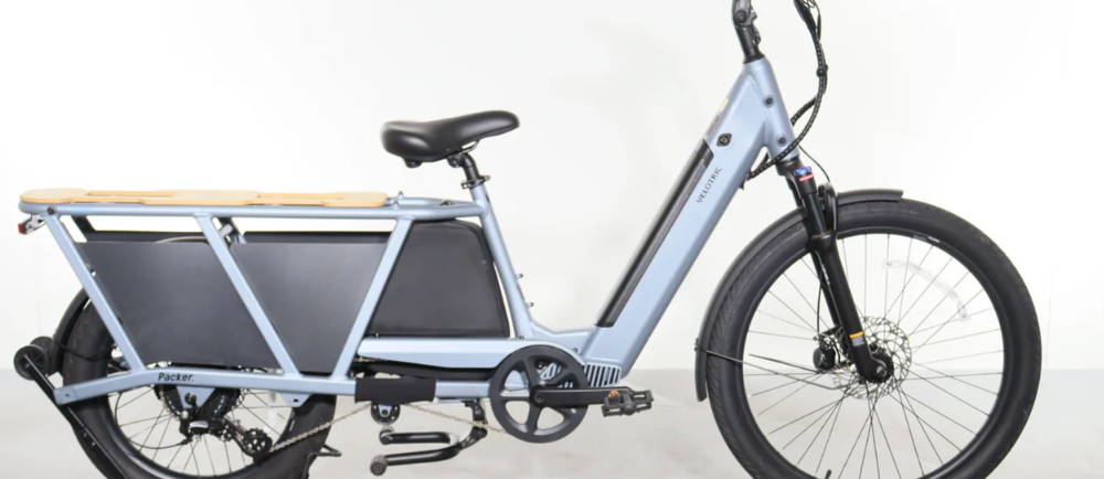 A light blue Velotric Packer 1 electric cargo bike