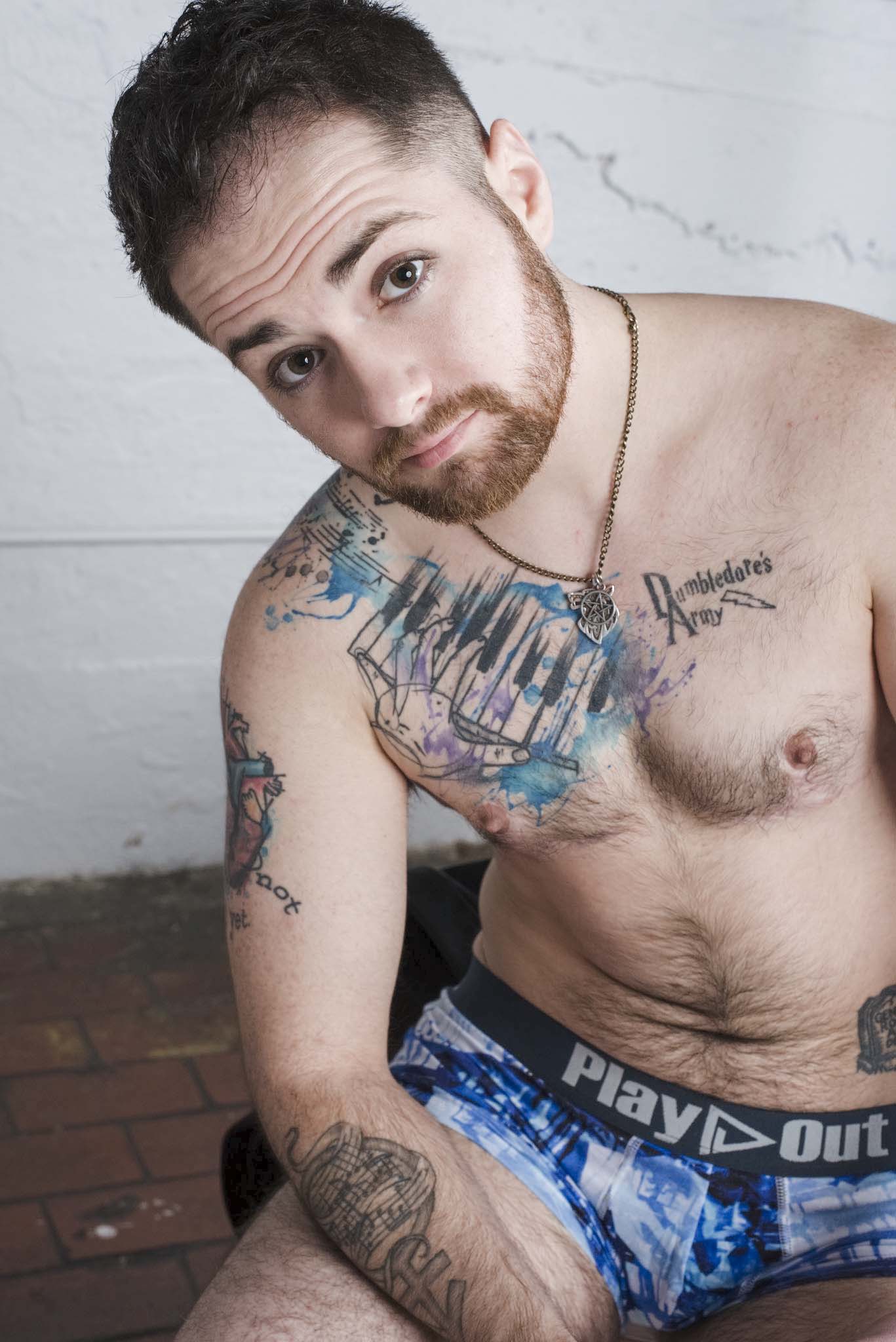Tony D, musician and composer, caucasian trans man, poses in Play Out gender equal trunks underwear.