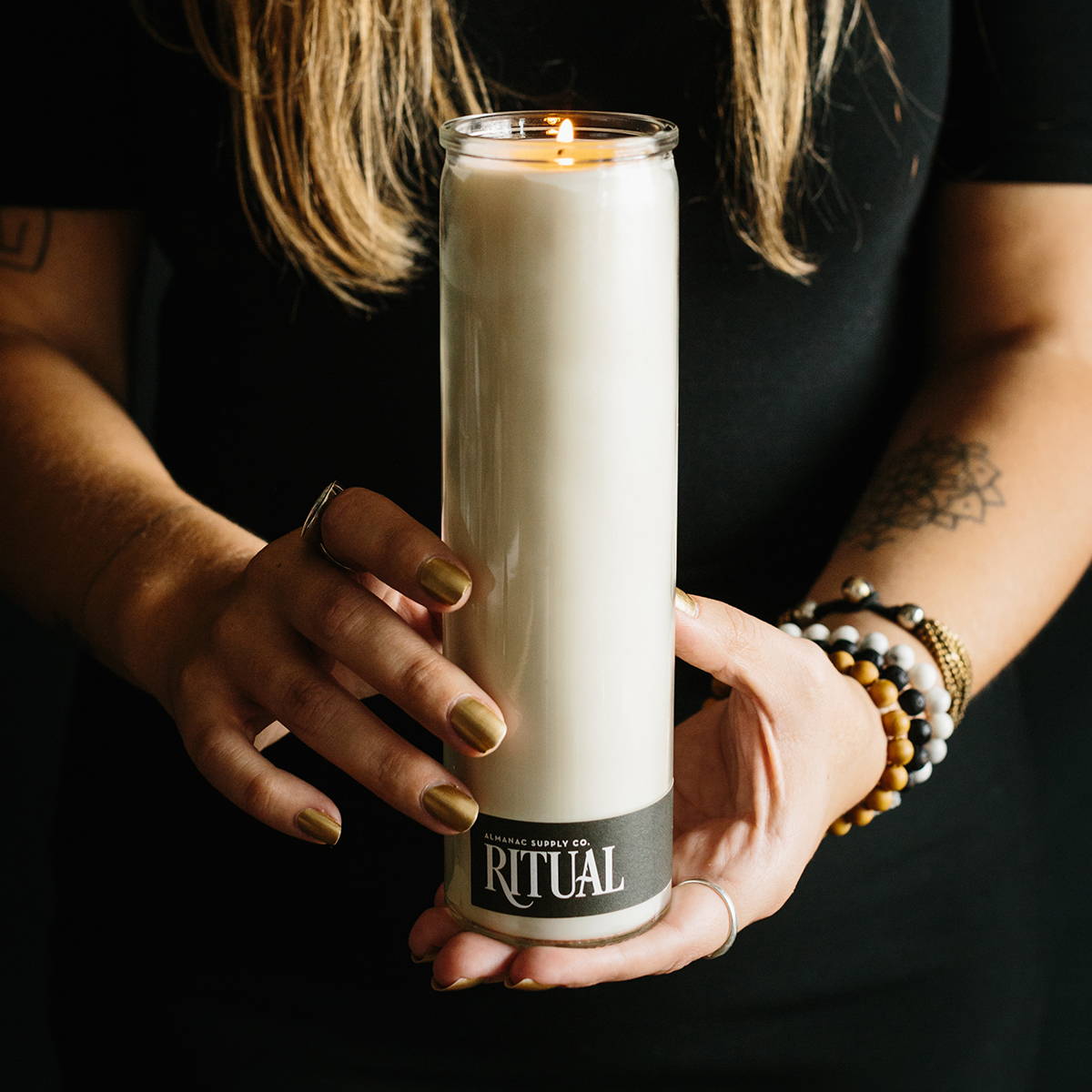 Hands holding a hand-poured ritual candle, making locally in Chattanooga TN
