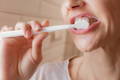 close up of woman brushing teeth