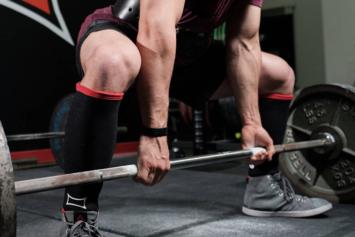 Powerlifter with a Barbell in Deadlift Shin Guards