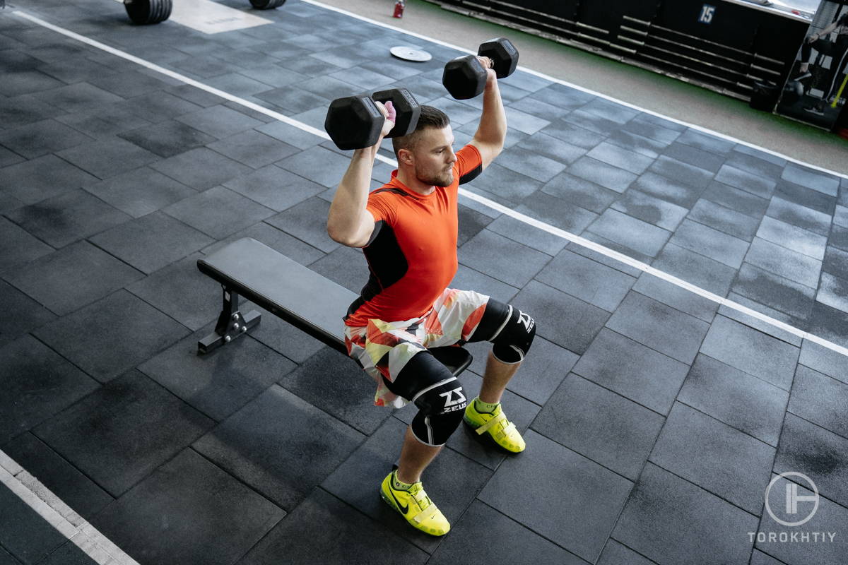 athlete training with weight bench