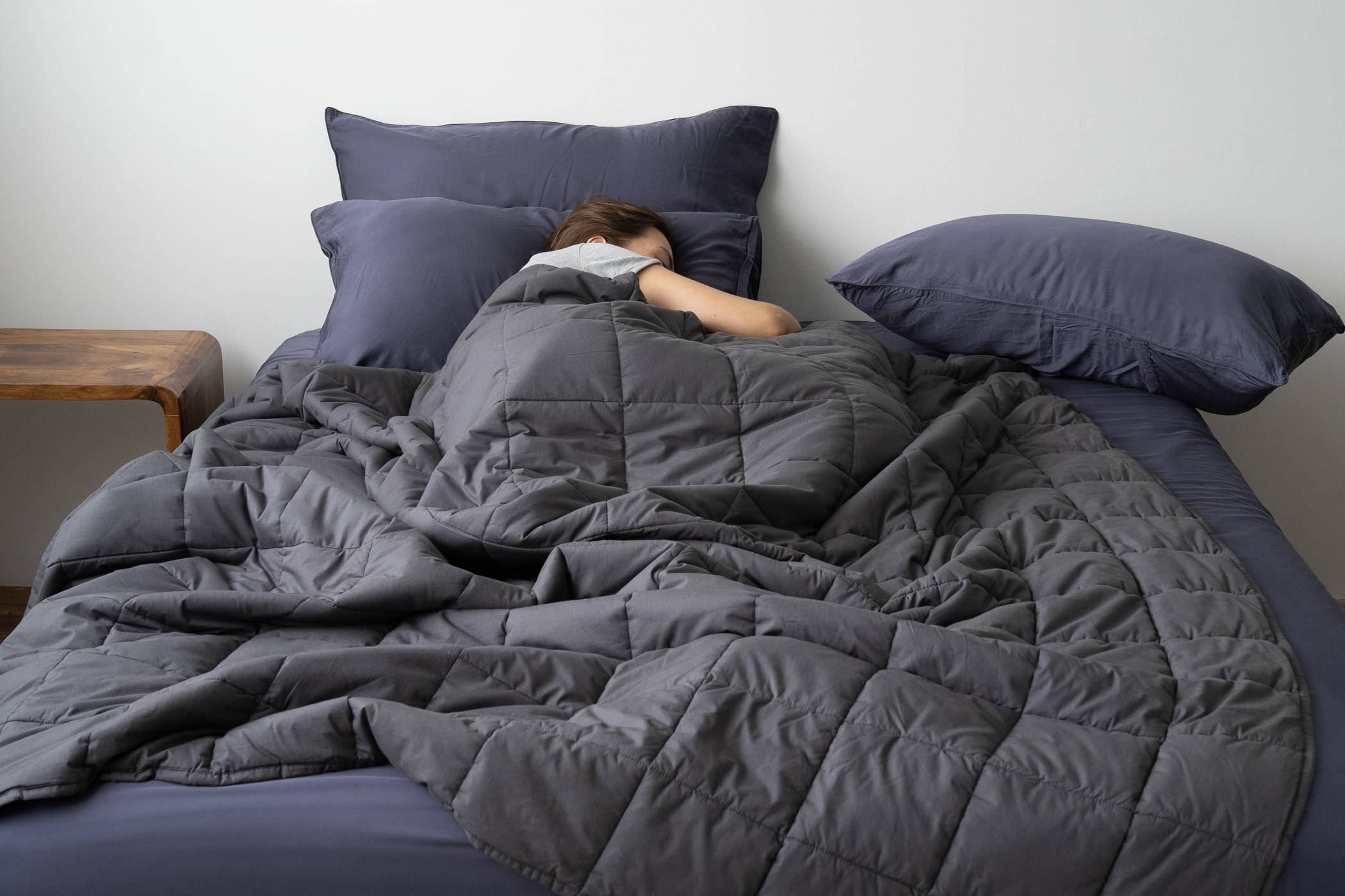 Woman sleeping with a weighted blanket