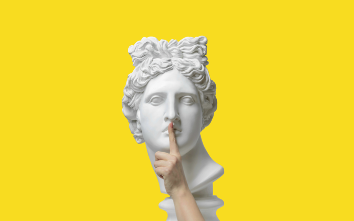 A finger held up to a statue head in a silencing gesture for Confetti's Virtual Taboo Game