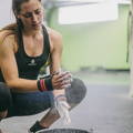 Female athlete using chalk before her workout set
