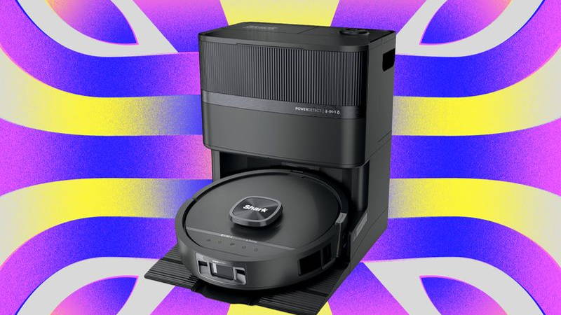 Disc-shaped robot vacuum docked inside a rectangular upright base