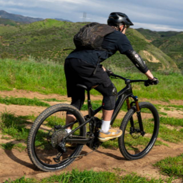 a man riding a full suspension electric mountain bike in the los angeles mountains