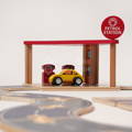 Wooden petrol station toy with a car track, gas truck and a wooden car.