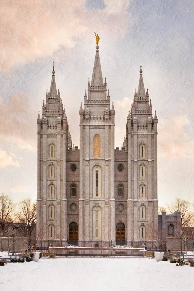 Vertical photo of the Salt Lake Temple. Snow covers the ground. 