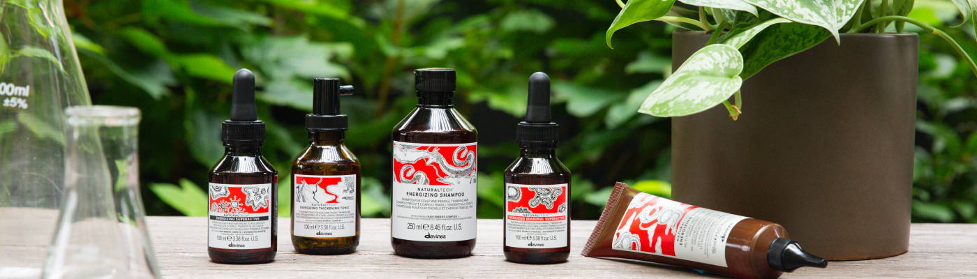 Davines ENERGIZING product line surrounded by plants