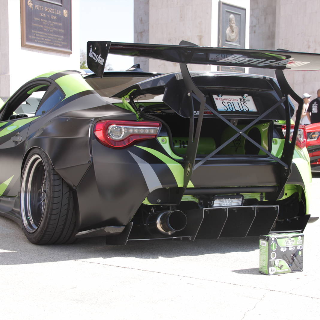 Flat Tire Repair Kit in front of Fancy Car