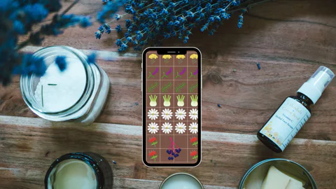 An herbal body care garden plan on the Planter App surrounded by herbal skin care products