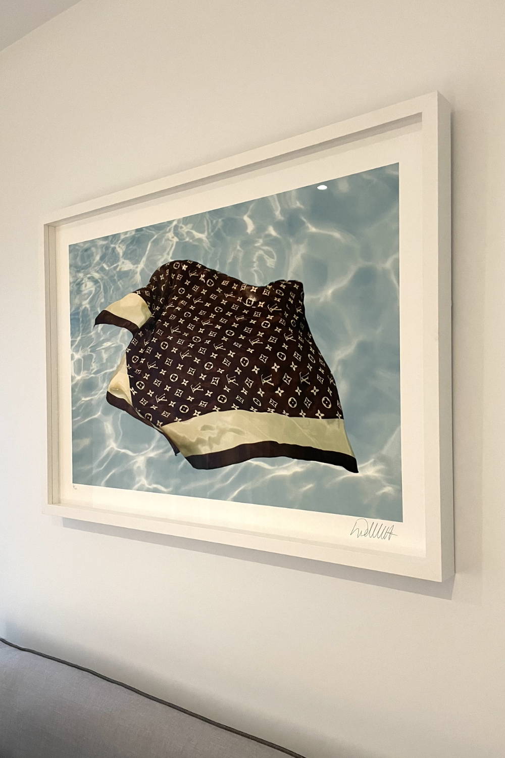 'Underwater Love' by Dina Broadhurst - An art print featuring a Louis Vuitton silk scarf floating in water, framed and hanging in a bedroom setting 
