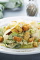 ceasar salad on a plate with croutons