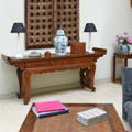 An antique Chinese altar table in an Oriental Eastern living room with Indian doors mounted above as wall art
