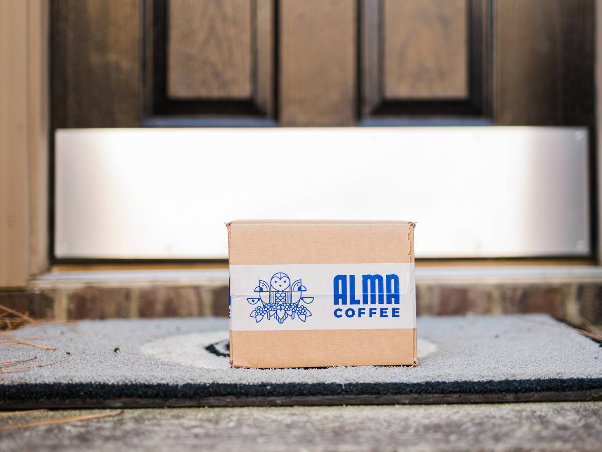 Box of coffee sitting on doorstep.