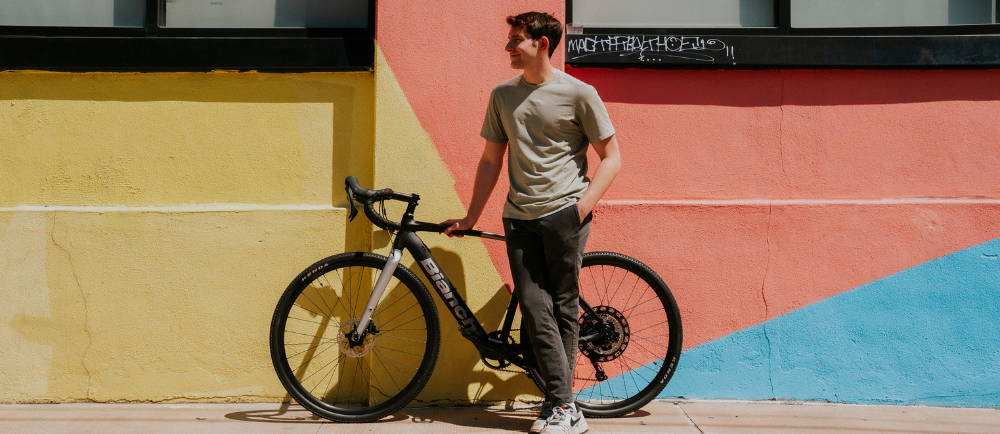 Man standing next to Bianchi Impulso electric road bike
