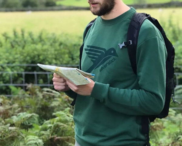 Man wearing green organic cotton sweatshirt from sustainable outdoor clothing brand Silverstick