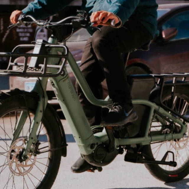 a man riding a Momentum PakYak E+ electric cargo bike
