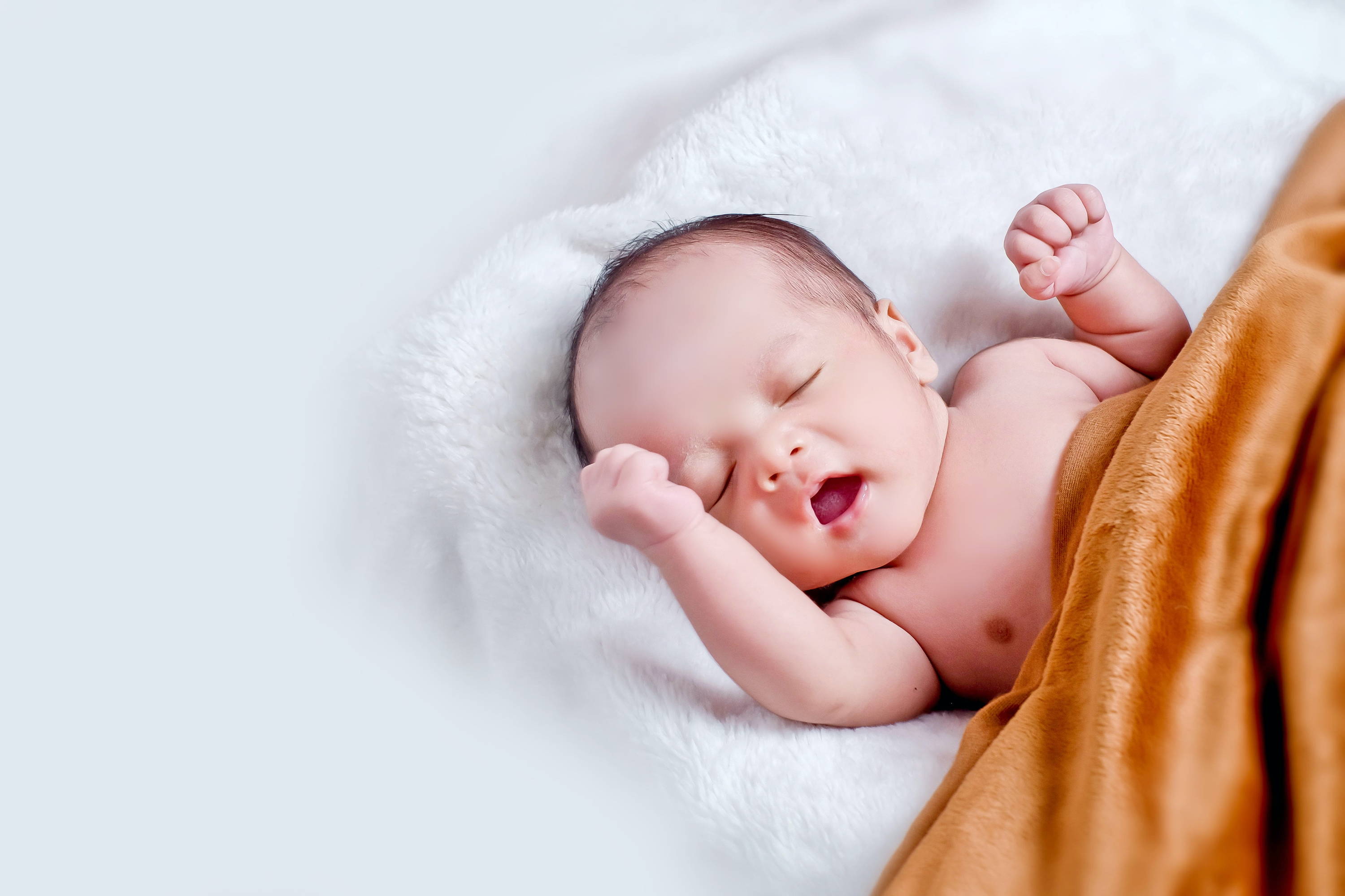 Baby sleeping next to Baby Mood Lamp