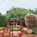 Child playing with the Montessori Farm life figurine set. 